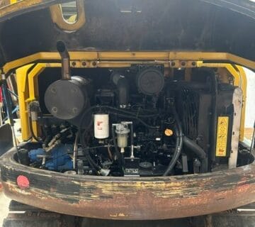 Close-up of mini excavator engine and hydraulic system. - For Sale